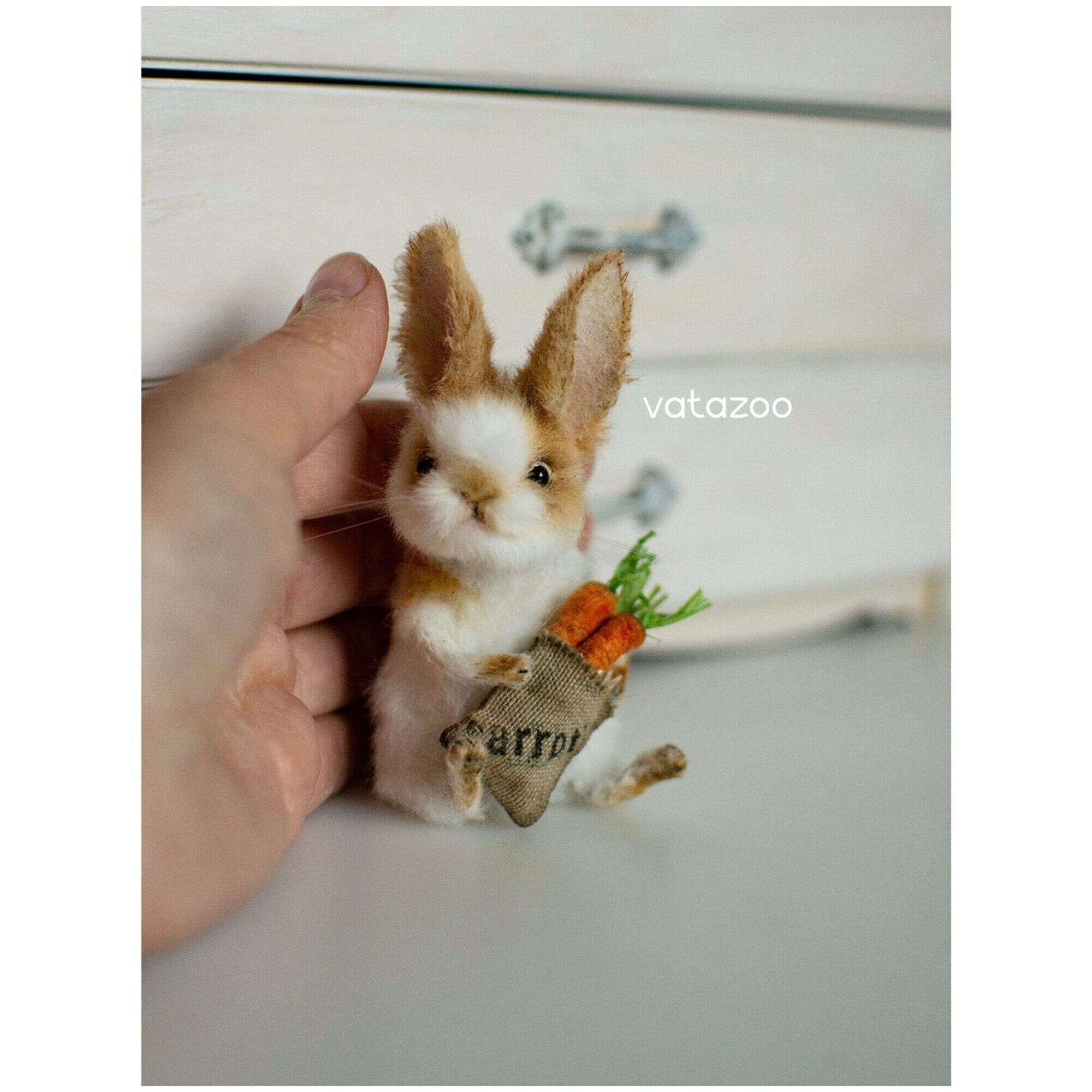 White bunny with movable limbs and a bag of carrots